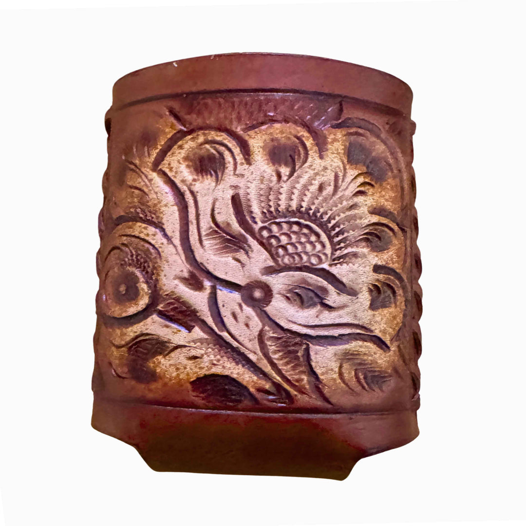 Close-up of hand tooling on the brown leather coozie