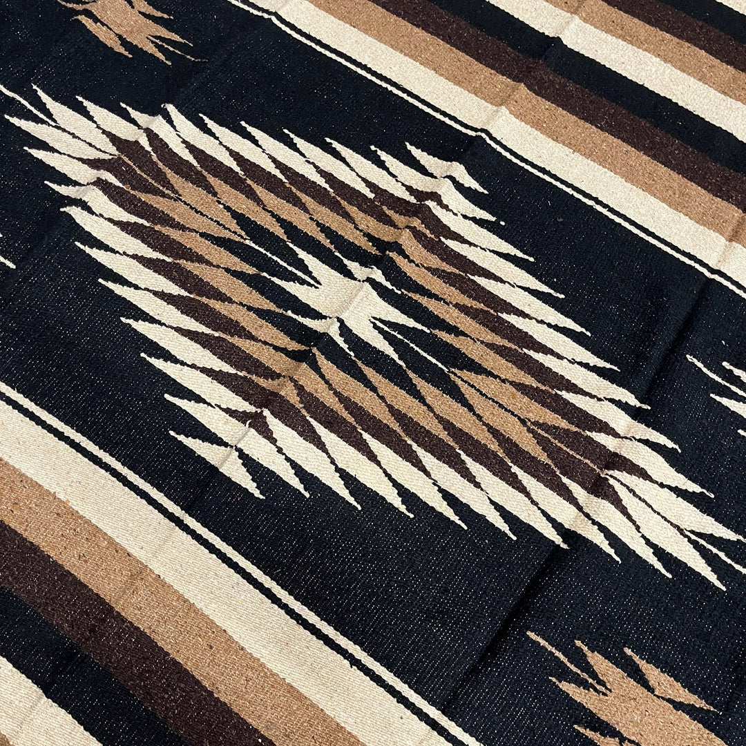 Close-up of a patterned fabric with geometric design on a dark background