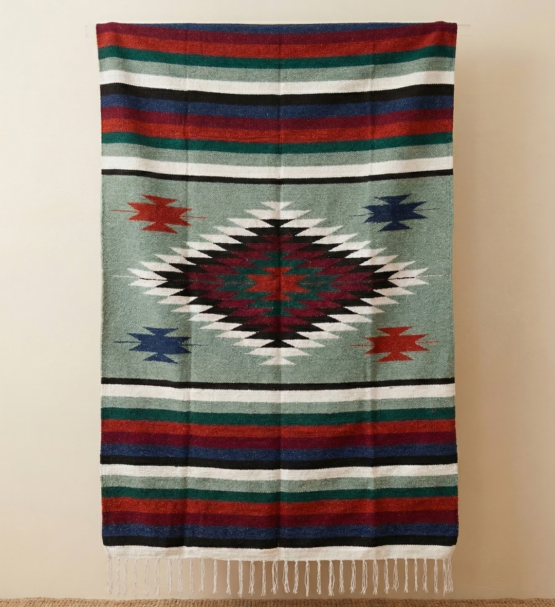 Colorful patterned blanket with geometric design on a beige background