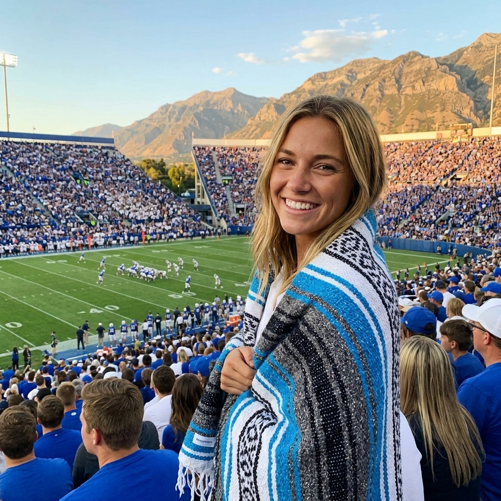 Fan wrapped in a Mexican stadium blanket in Brigham Young University colors at a college football game