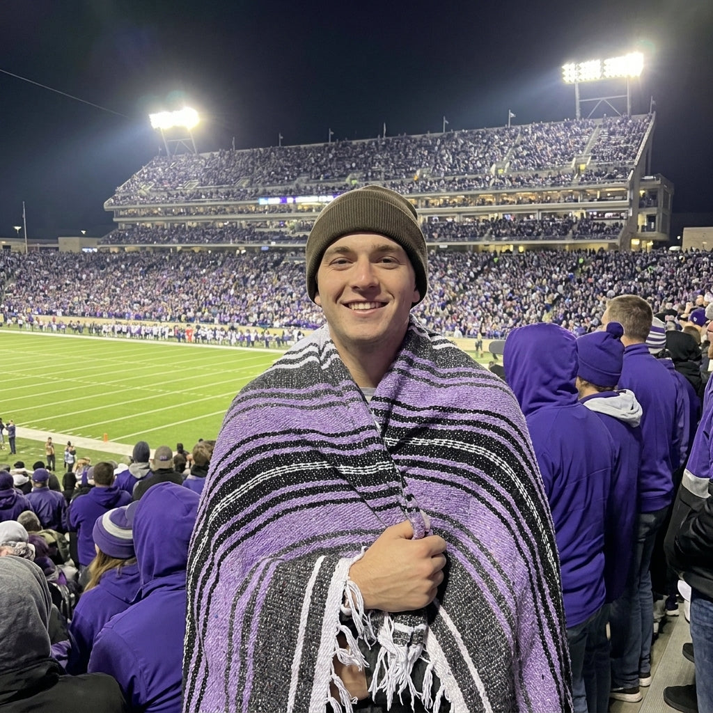 Fan wrapped in a Mexican stadium blanket in Kansas State University colors at a college football game