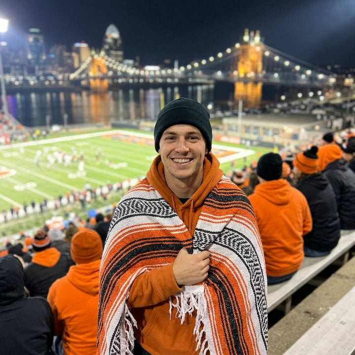 Fan wrapped in a Mexican stadium blanket at a Cincinnati football game