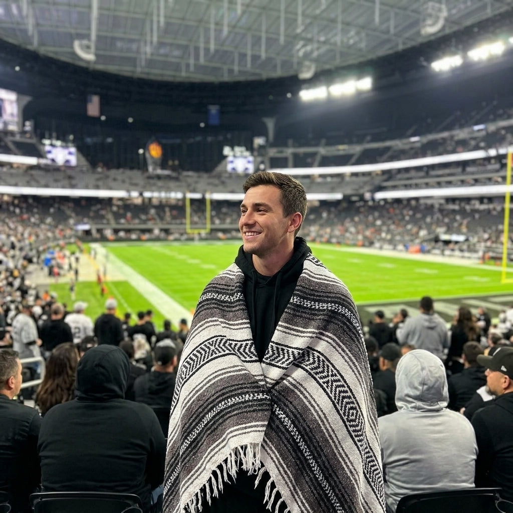 Fan wrapped in a Mexican stadium blanket at a Las Vegas football game
