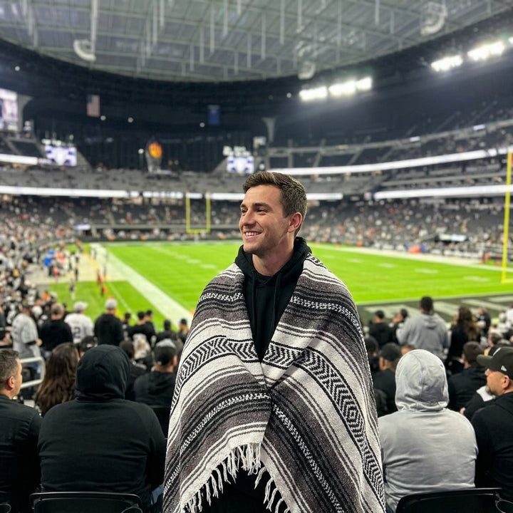 Fan wrapped in a Mexican stadium blanket at a Las Vegas football game