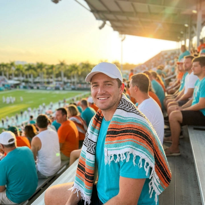 Fan wrapped in a Mexican stadium blanket at a Miami football game