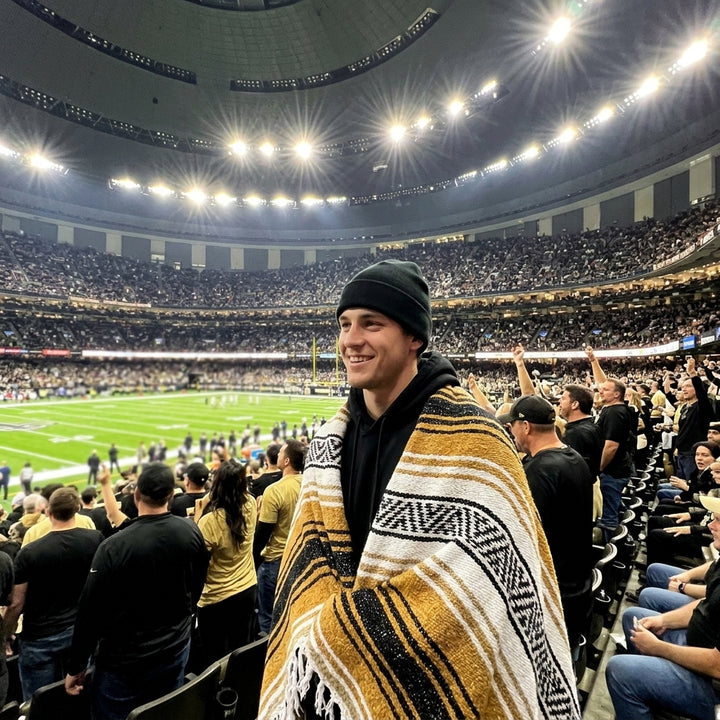 Fan wrapped in a Mexican stadium blanket at a New Orleans football game