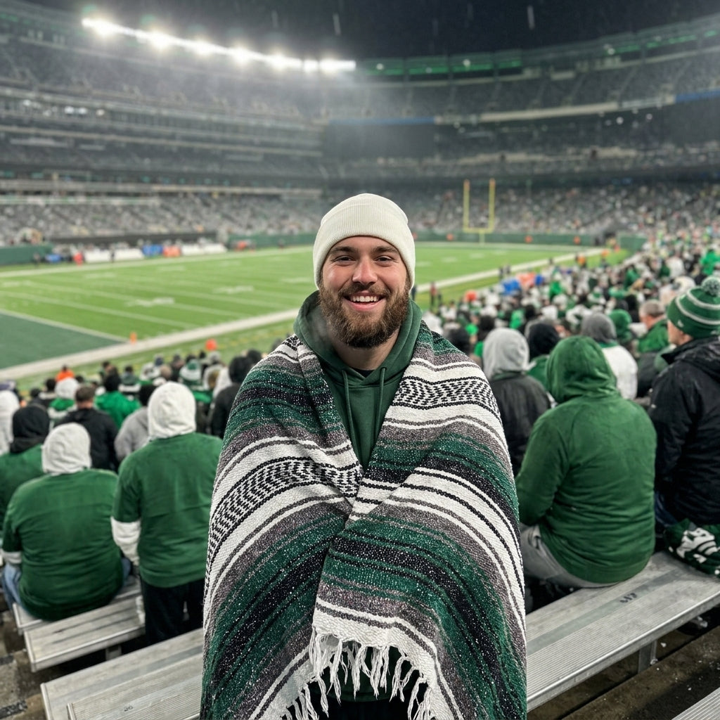 Fan wrapped in a Mexican stadium blanket at a New York football game