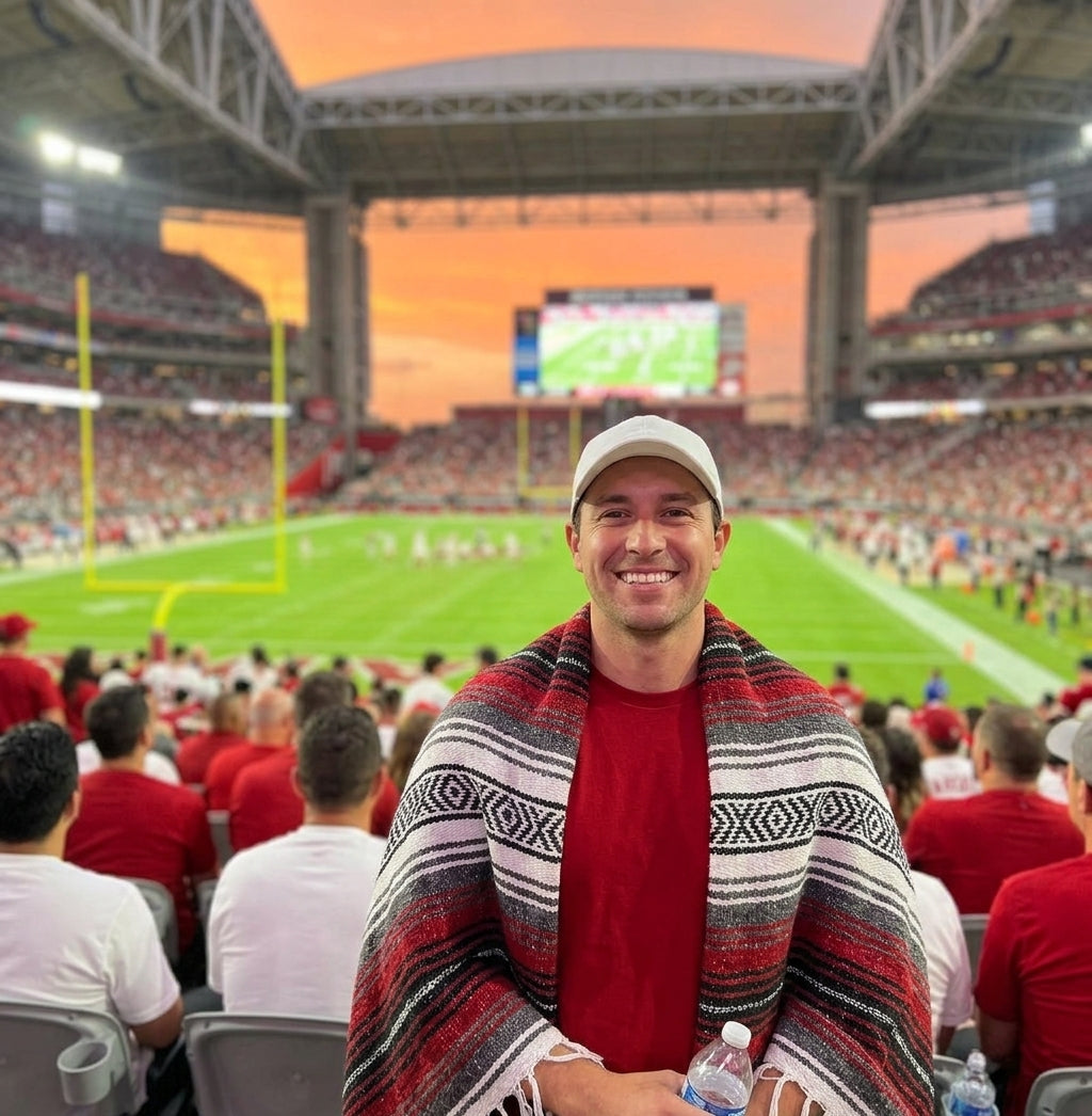 Fan wrapped in a Mexican stadium blanket at a Phoenix football game