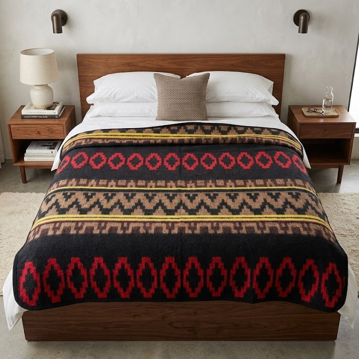 Bedroom with a wooden bed and patterned blanket