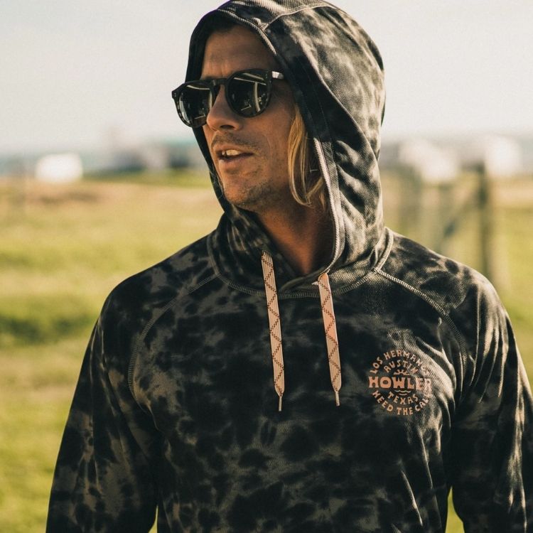 Howler Bros' Street colored loggerhead hoodie shot on a male in a lifestyle shot
