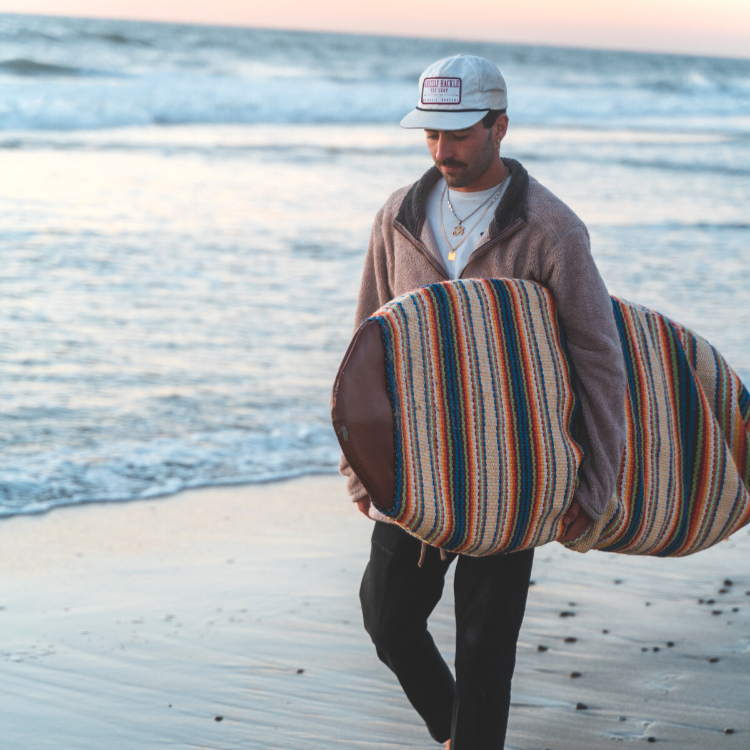 Surfer carrying board